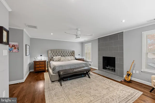 a spacious bedroom with a bed and a fireplace