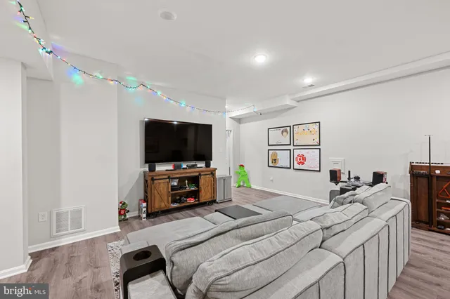 a bedroom with furniture and a flat screen tv