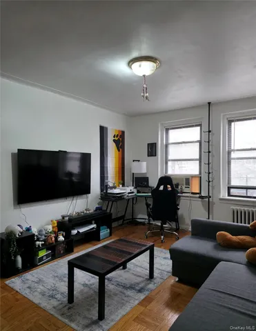 a living room with furniture and a flat screen tv