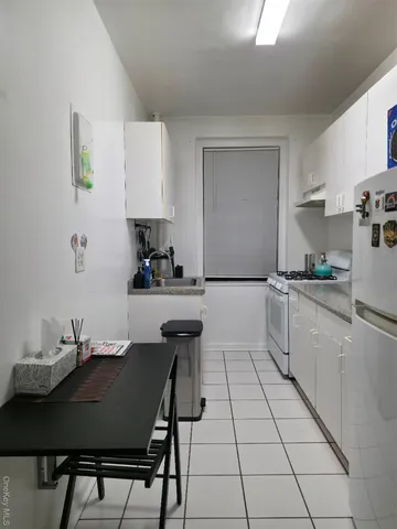 a kitchen with a table chairs and a refrigerator