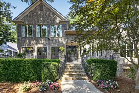 a front view of a house with a garden