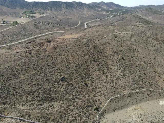 a view of a dry yard with mountains