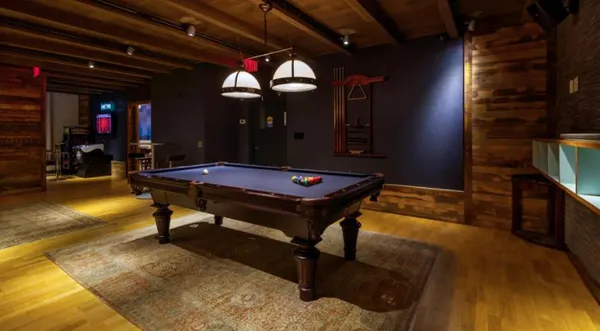 a room with furniture pool table and flat screen tv