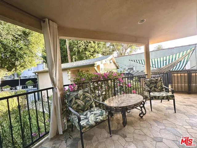 a view of a chairs and table in the balcony