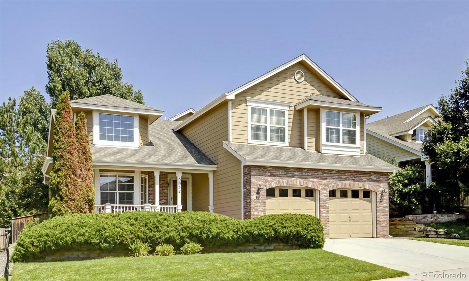 9932 South Spring Hill Place Highlands Ranch, CO 80129 - Photo 1 of 31 a front view of a house with a yard