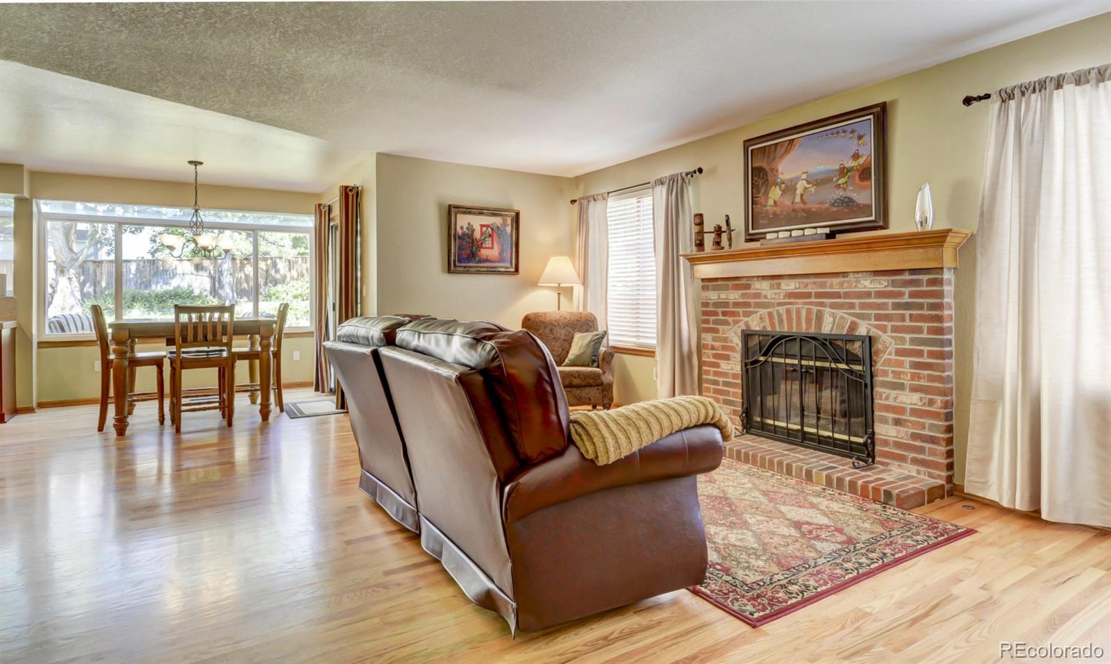 9932 South Spring Hill Place Highlands Ranch, CO 80129 - Photo 13 of 31 a living room with furniture and a fireplace