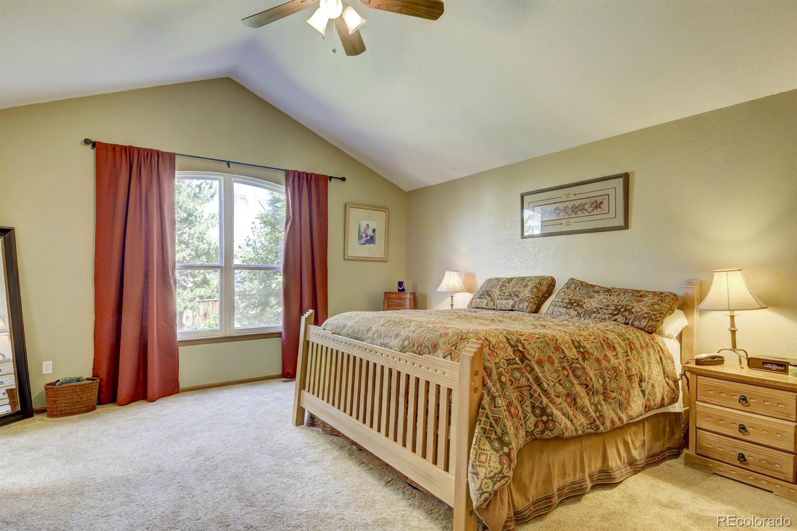 9932 South Spring Hill Place Highlands Ranch, CO 80129 - Photo 14 of 31 a bed sitting in a spacious bedroom next to a window