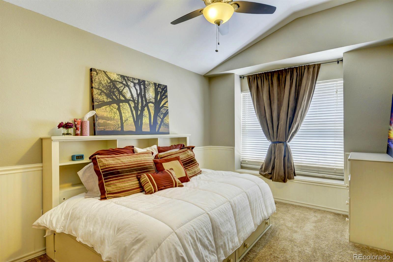 9932 South Spring Hill Place Highlands Ranch, CO 80129 - Photo 21 of 31 a bedroom with a bed and a painting on the wall