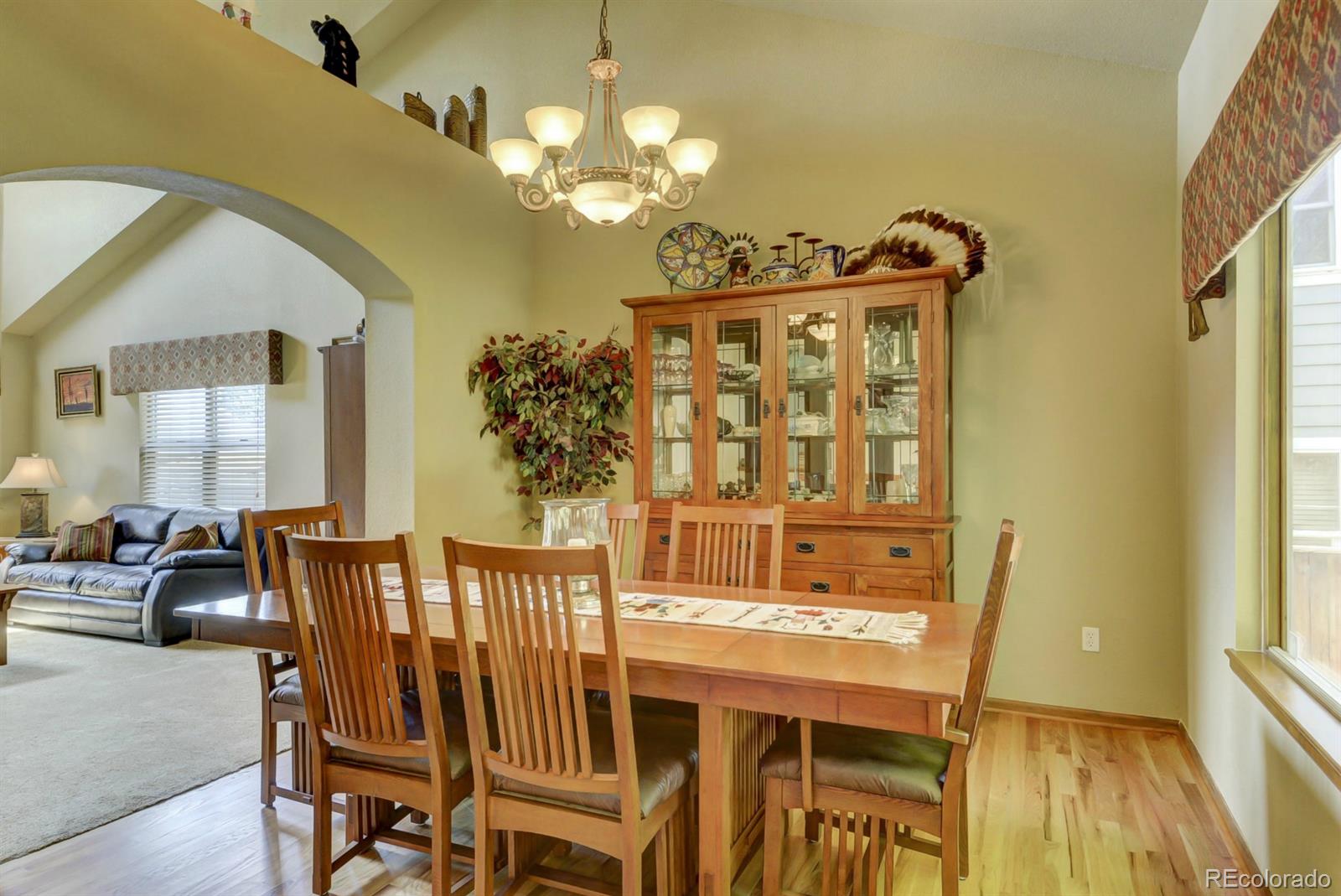 9932 South Spring Hill Place Highlands Ranch, CO 80129 - Photo 8 of 31 a view of a dining room with furniture and wooden floor