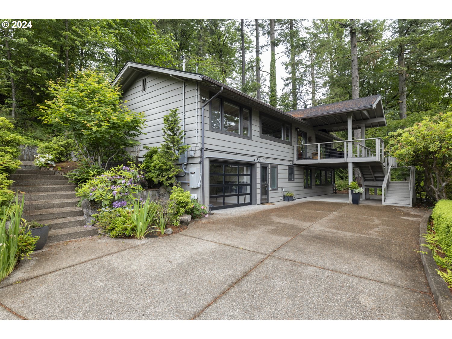 495 Northwest Greenleaf Road Portland, OR 97229 - Photo 1 of 45 a front view of a house with a garden