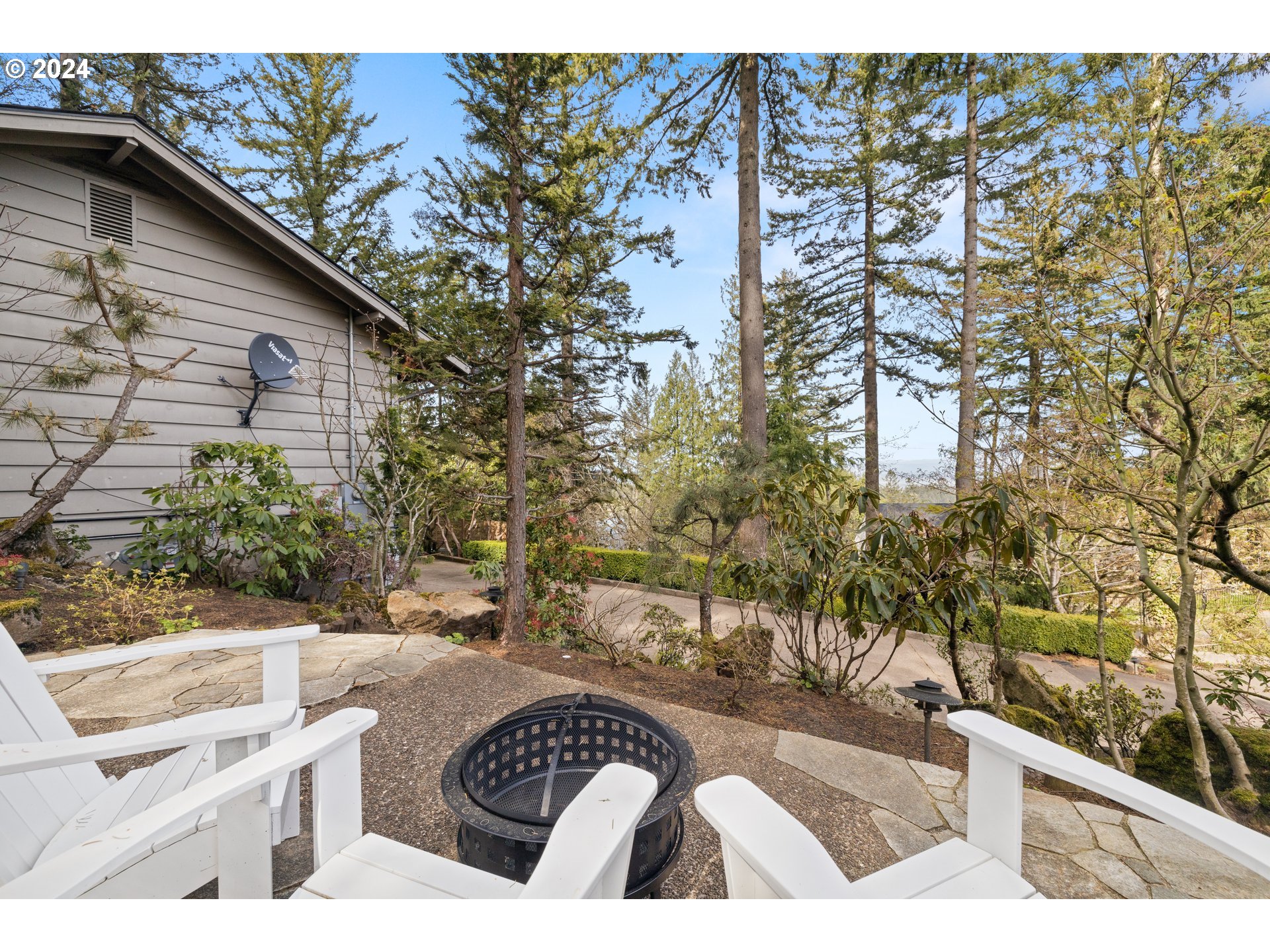 495 Northwest Greenleaf Road Portland, OR 97229 - Photo 35 of 45 a view of a patio with couches and table with chairs and potted plants