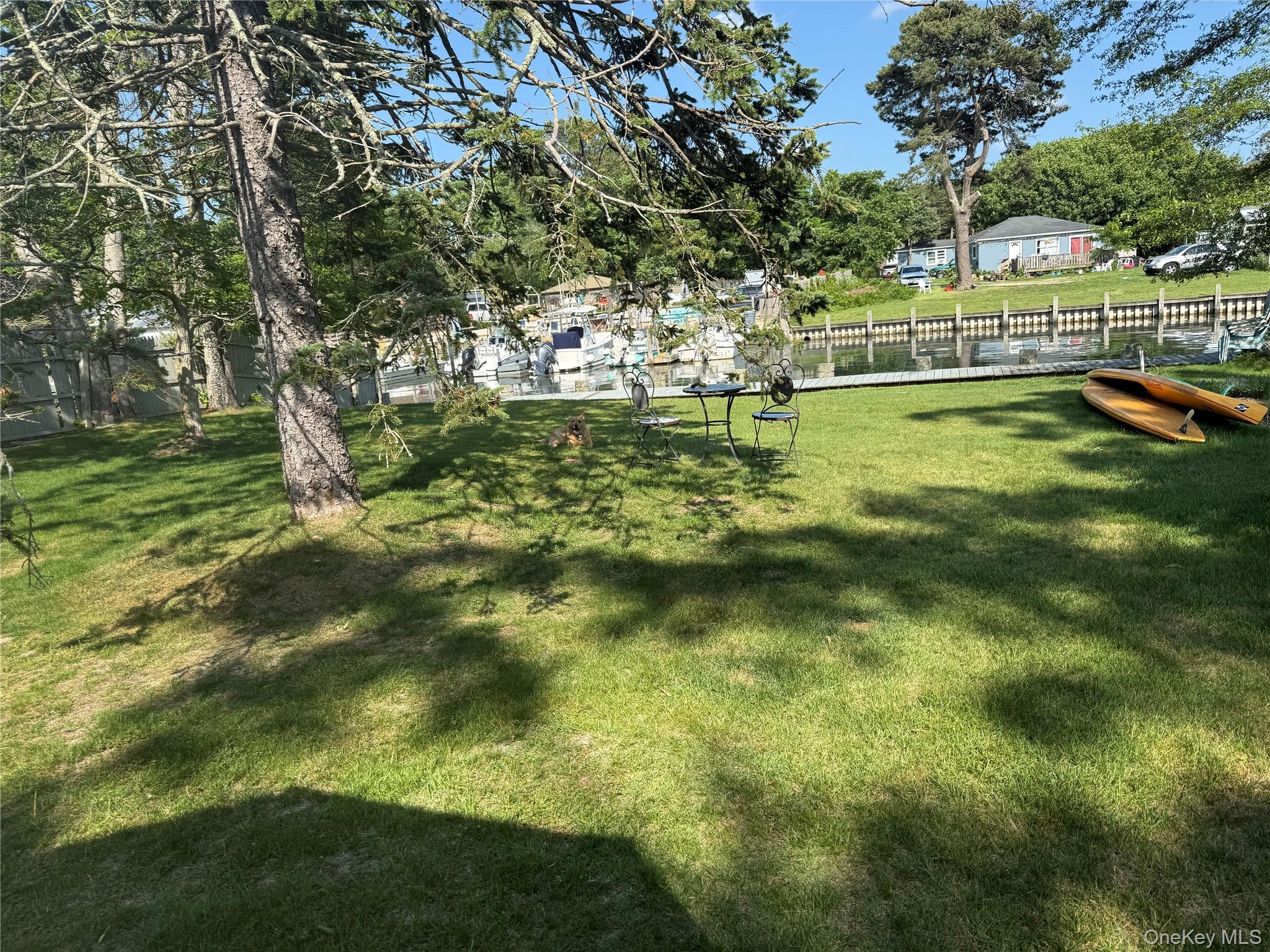 18 Shinnecock Road, Unit 3 Hampton Bays, NY 11946 - Photo 4 of 8 Canal view private backyard to enjoy summer days under a tree by the water.