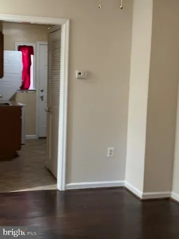 a view of an empty room and wooden floor