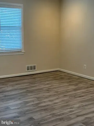 a view of hallway with wooden floor