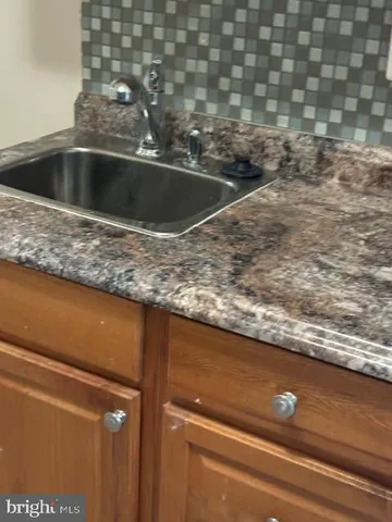 a view of a room with wooden floor and a window