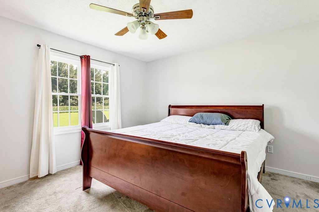 1018 Eubanks Road Dunnsville, VA 22454 - Photo 11 of 26 a bed sitting in a bedroom next to a window