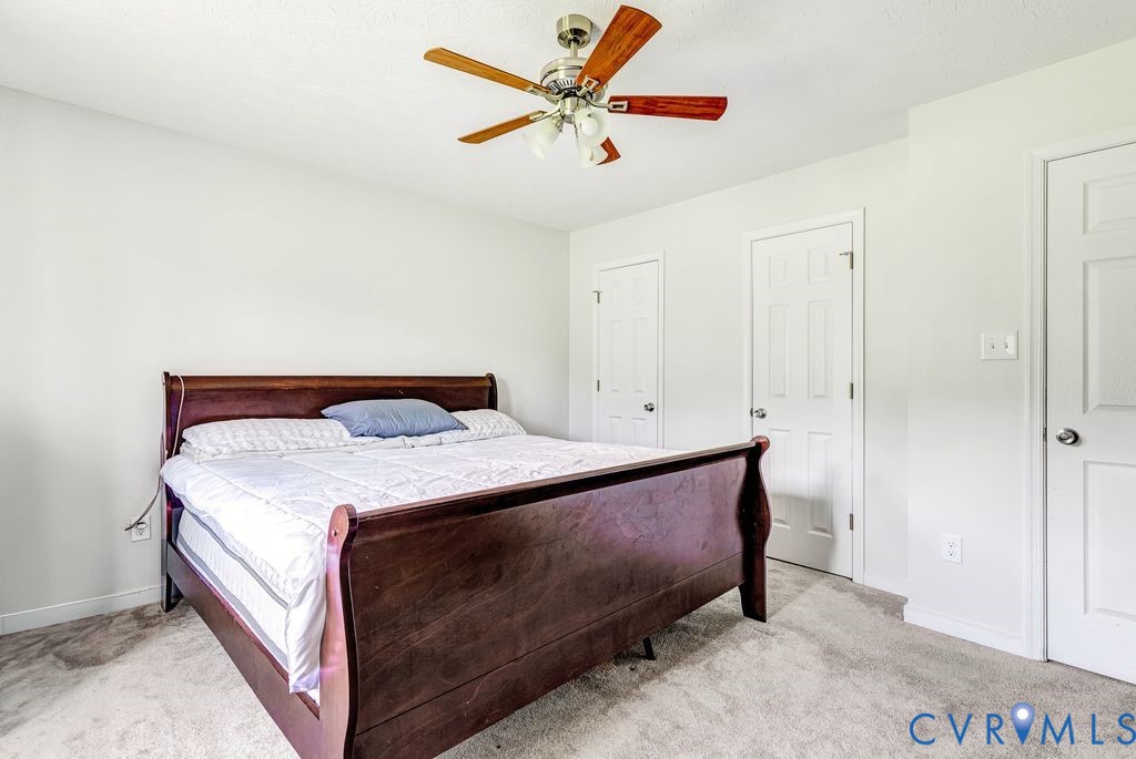 1018 Eubanks Road Dunnsville, VA 22454 - Photo 12 of 26 a bedroom with a bed and a ceiling fan