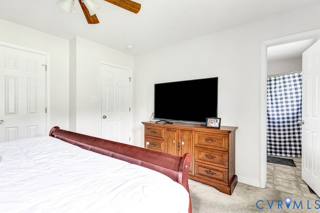 1018 Eubanks Road Dunnsville, VA 22454 - Photo 13 of 26 a bedroom with a bed and a flat screen tv