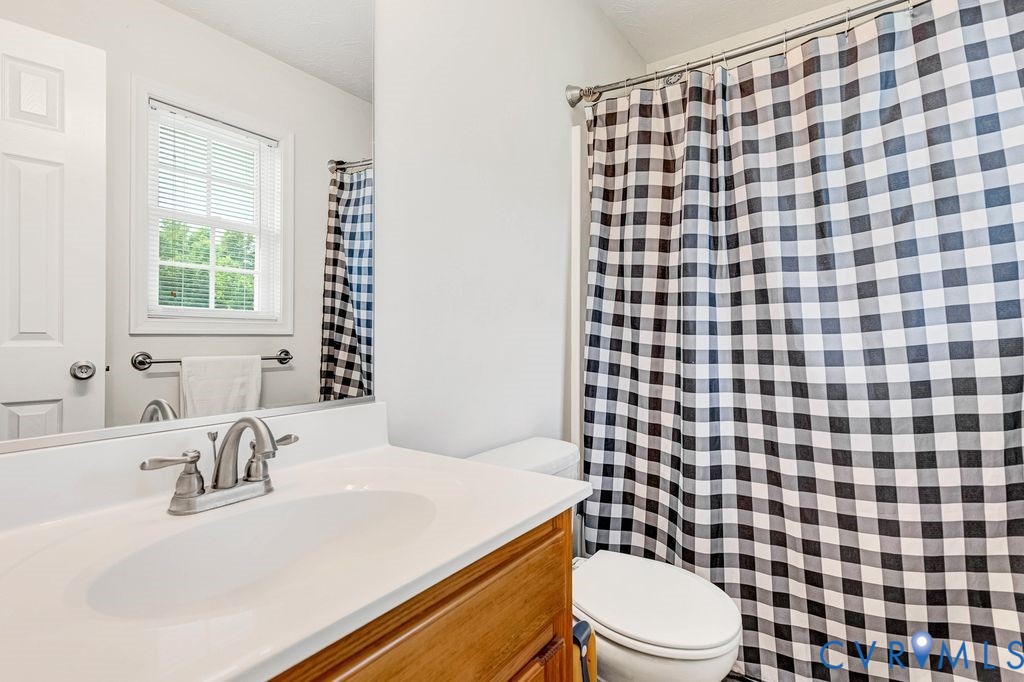 1018 Eubanks Road Dunnsville, VA 22454 - Photo 14 of 26 a bathroom with a sink toilet and shower