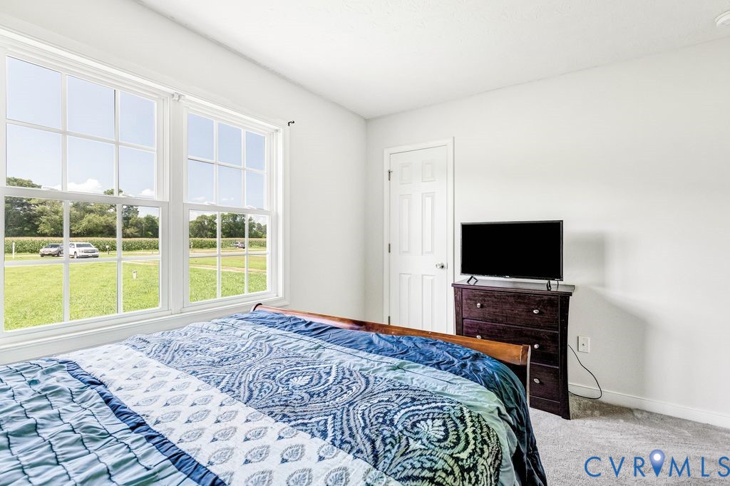 1018 Eubanks Road Dunnsville, VA 22454 - Photo 16 of 26 a bedroom with a bed and a television