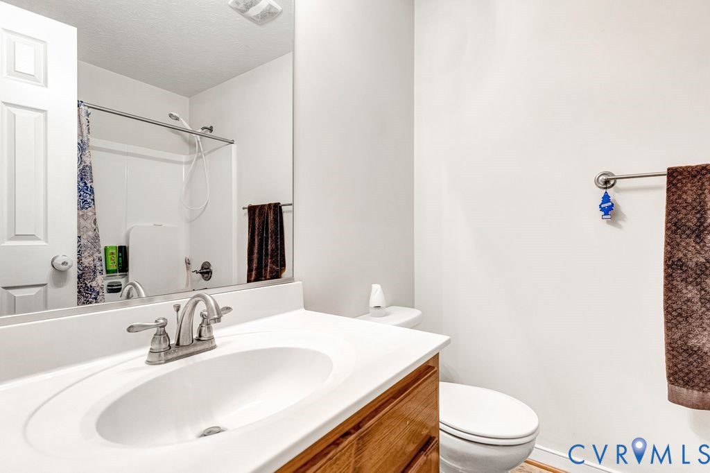 1018 Eubanks Road Dunnsville, VA 22454 - Photo 18 of 26 a bathroom with a sink a toilet and shower