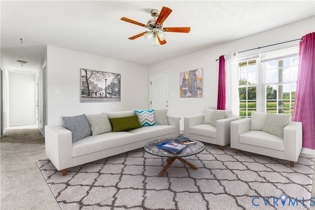 1018 Eubanks Road Dunnsville, VA 22454 - Photo 6 of 26 a living room with furniture and a large window