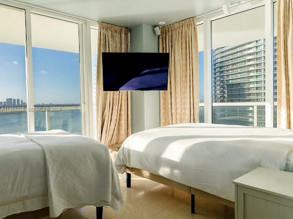450 Alton Road, Unit 1202 Miami Beach, FL 33139 - Photo 23 of 68 a bedroom with a bed and large window with outer view