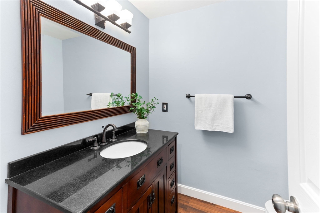 511 Tumbling Hawk, Unit 511 Acton, MA 01718 - Photo 17 of 42 a bathroom with a granite countertop sink and a mirror