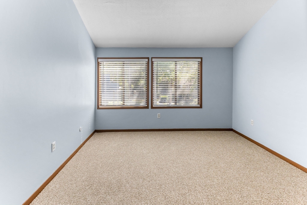 511 Tumbling Hawk, Unit 511 Acton, MA 01718 - Photo 20 of 42 an empty room with a window