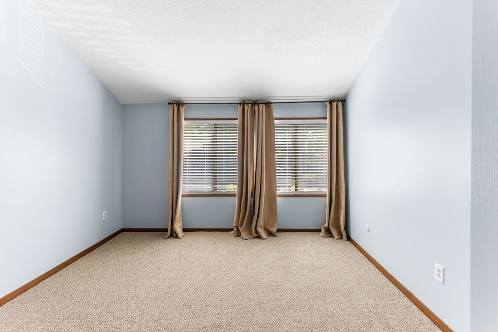 511 Tumbling Hawk, Unit 511 Acton, MA 01718 - Photo 21 of 42 an empty room with windows