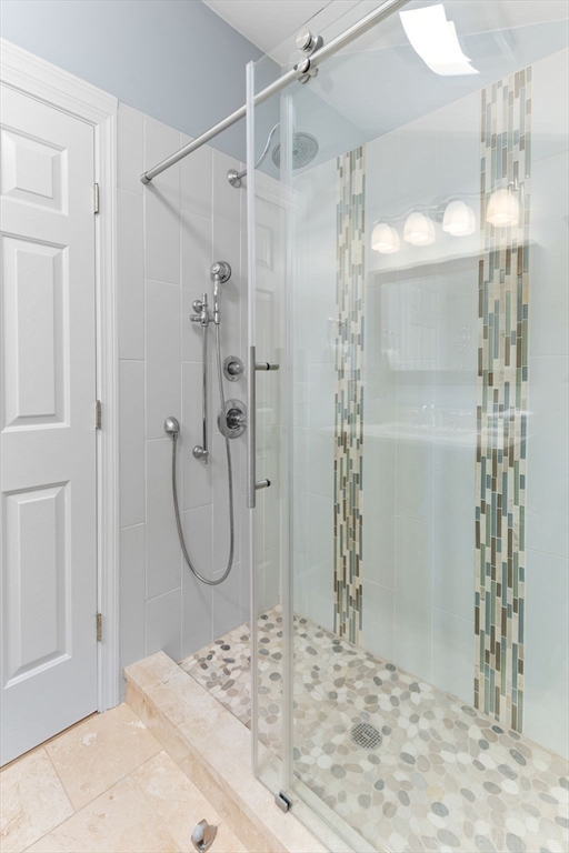 511 Tumbling Hawk, Unit 511 Acton, MA 01718 - Photo 25 of 42 a bathroom with a shower and a sink