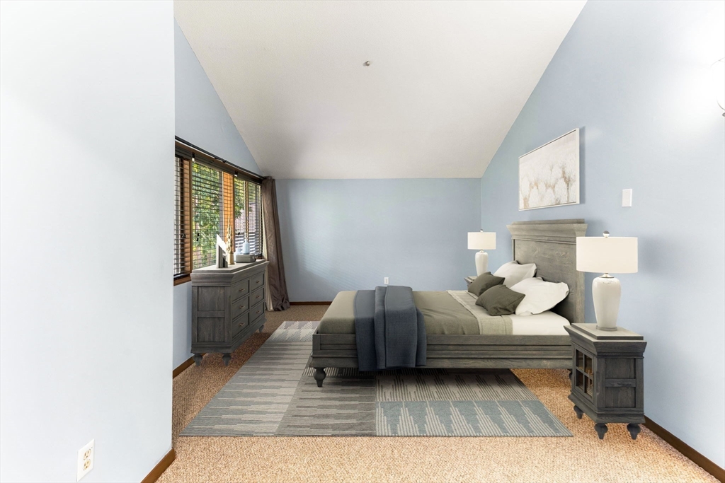 511 Tumbling Hawk, Unit 511 Acton, MA 01718 - Photo 27 of 42 a bedroom with a bed and window