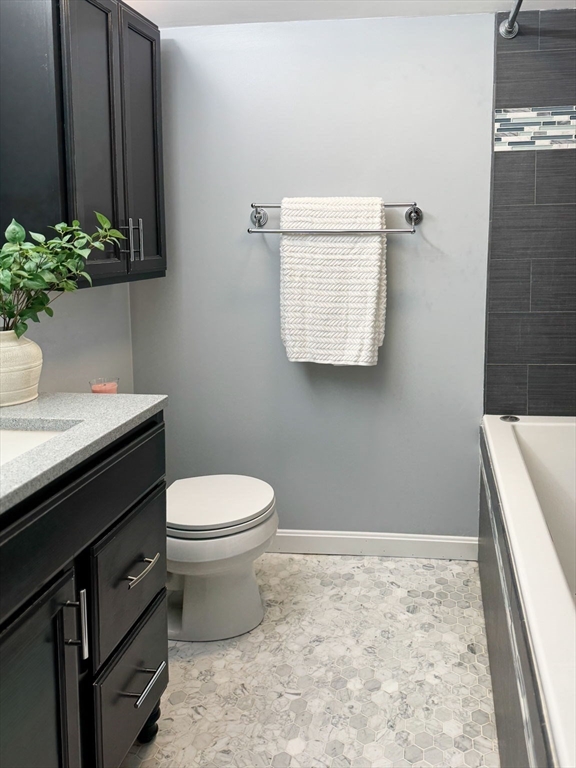 511 Tumbling Hawk, Unit 511 Acton, MA 01718 - Photo 29 of 42 a bathroom with a sink a toilet and vanity