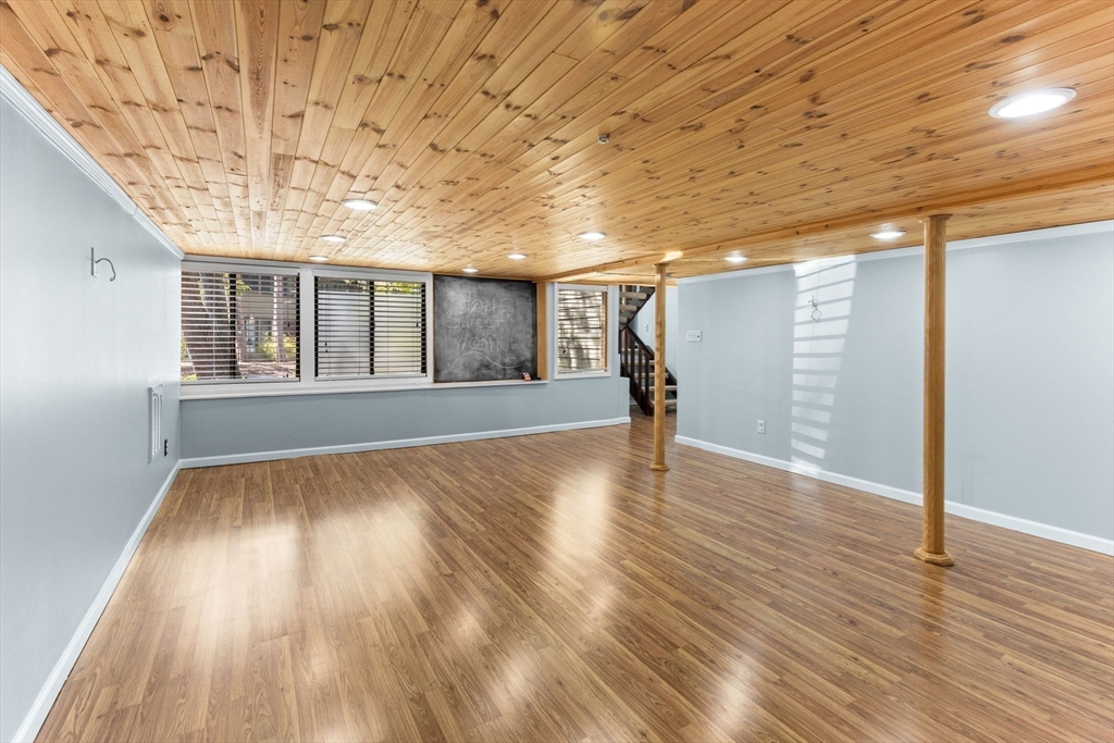 511 Tumbling Hawk, Unit 511 Acton, MA 01718 - Photo 33 of 42 a view of an empty room with wooden floor and a window