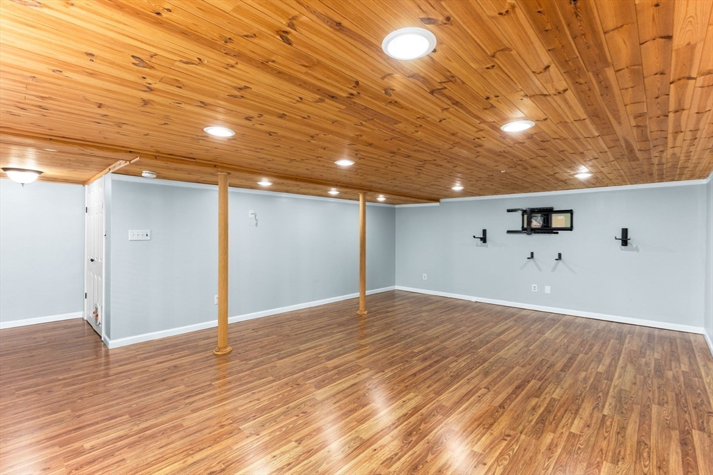 511 Tumbling Hawk, Unit 511 Acton, MA 01718 - Photo 35 of 42 a view of empty room with wooden floor