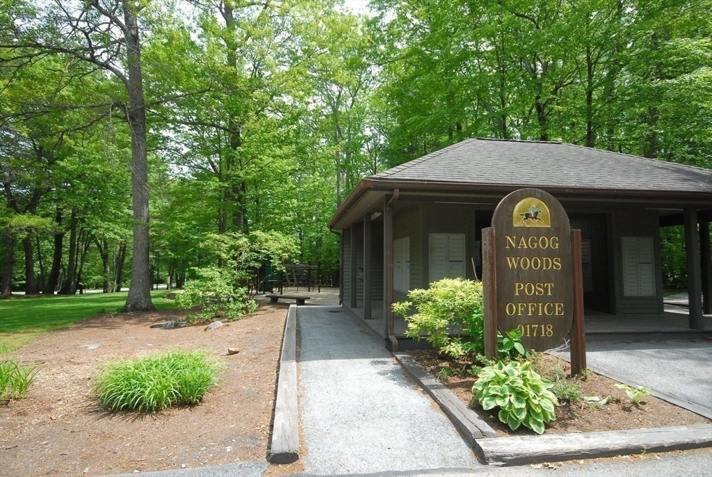 511 Tumbling Hawk, Unit 511 Acton, MA 01718 - Photo 39 of 42 a view of a sign board with flower plants