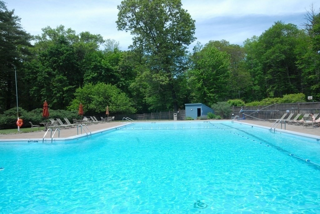 511 Tumbling Hawk, Unit 511 Acton, MA 01718 - Photo 40 of 42 a swimming pool with outdoor seating and yard