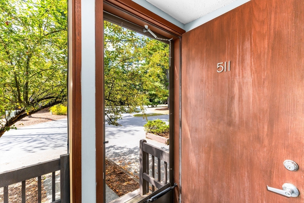 511 Tumbling Hawk, Unit 511 Acton, MA 01718 - Photo 4 of 42 a view of a porch and a yard