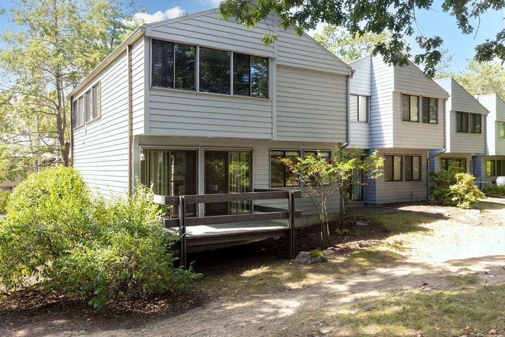 511 Tumbling Hawk, Unit 511 Acton, MA 01718 - Photo 8 of 42 a view of a house with a yard and sitting area