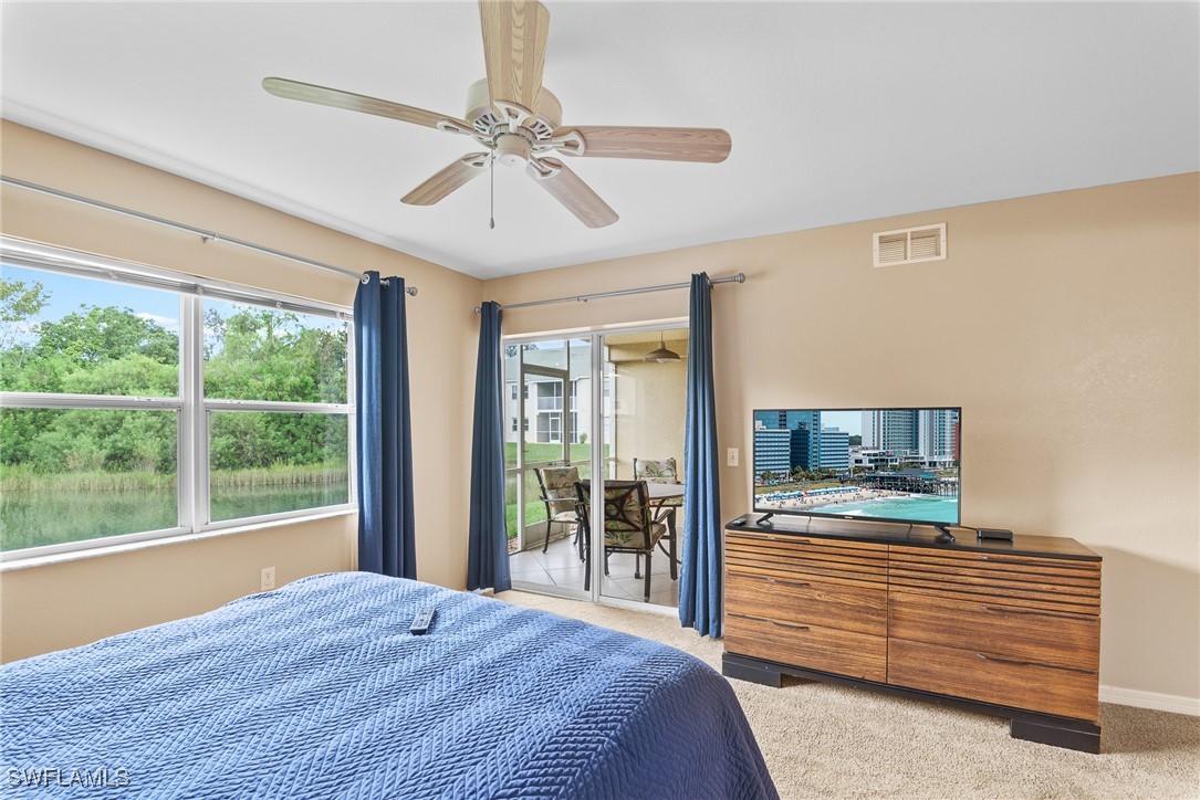4965 Sandra Bay Drive, Unit 103 Naples, FL 34109 - Photo 12 of 30 a bedroom with a bed and large window