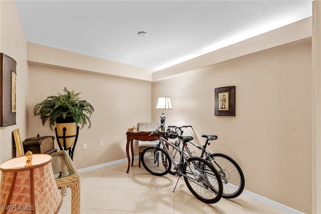 4965 Sandra Bay Drive, Unit 103 Naples, FL 34109 - Photo 15 of 30 a view of a room with gym equipment