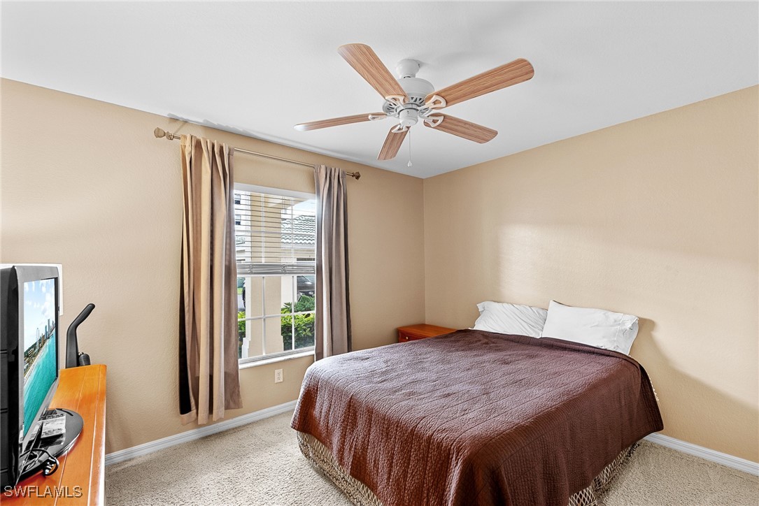 4965 Sandra Bay Drive, Unit 103 Naples, FL 34109 - Photo 16 of 30 a bedroom with a bed and a window