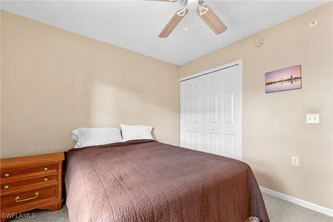 a bedroom with a bed and cabinet