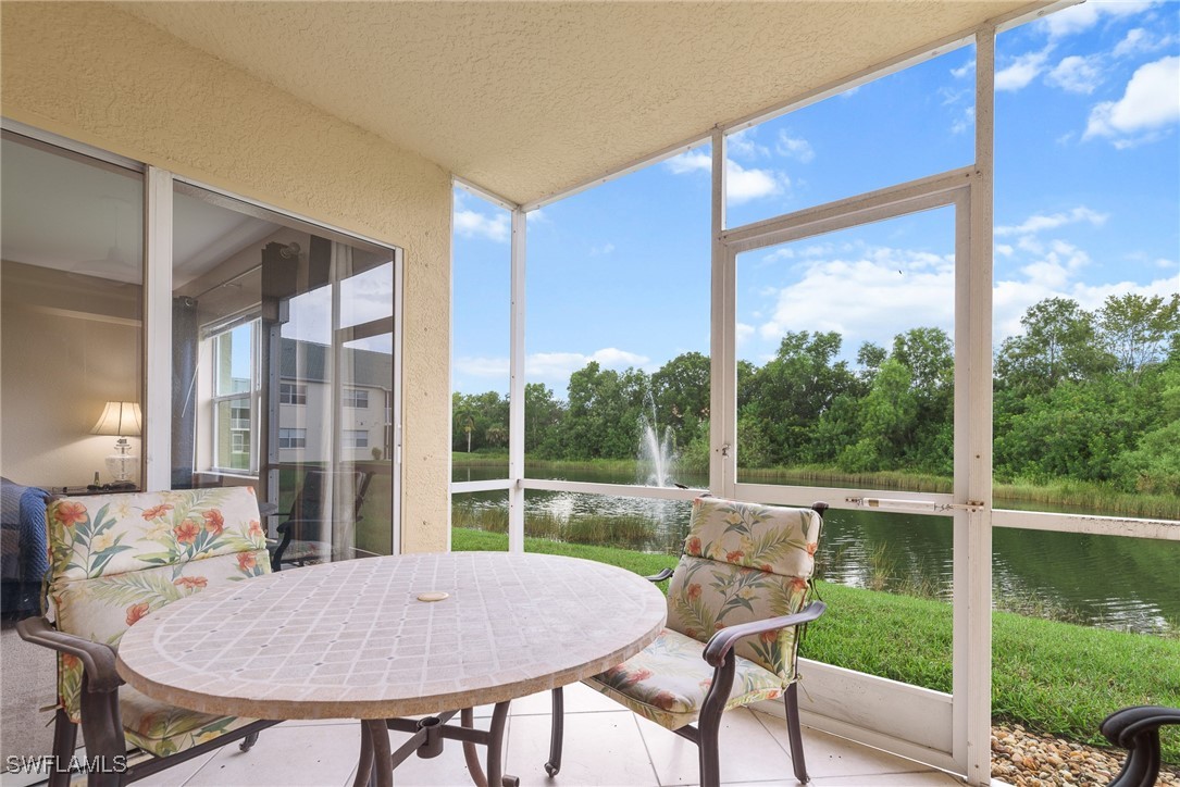 4965 Sandra Bay Drive, Unit 103 Naples, FL 34109 - Photo 19 of 30 a view of a porch with furniture and yard