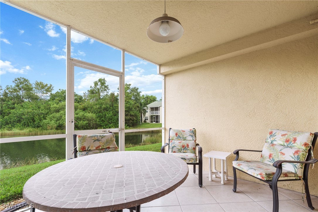 4965 Sandra Bay Drive, Unit 103 Naples, FL 34109 - Photo 20 of 30 a view of a dining room with a table and chairs