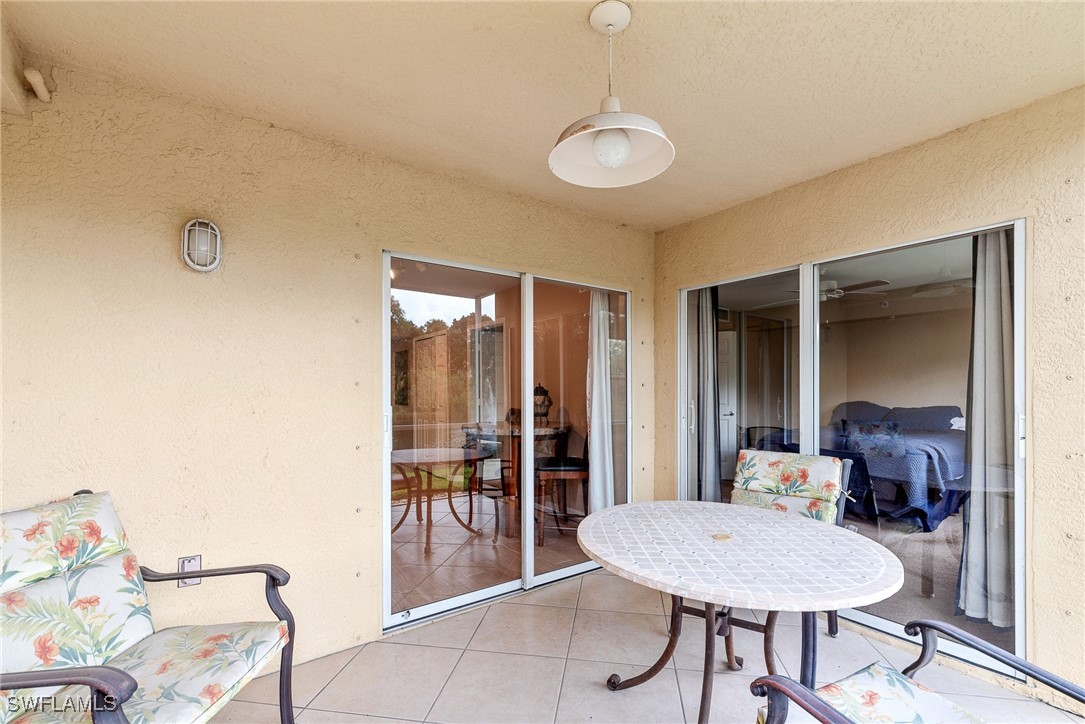 4965 Sandra Bay Drive, Unit 103 Naples, FL 34109 - Photo 21 of 30 a view of a livingroom with furniture and window