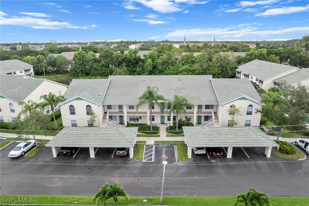 4965 Sandra Bay Drive, Unit 103 Naples, FL 34109 - Photo 22 of 30 an aerial view of a house with a big yard and large tree