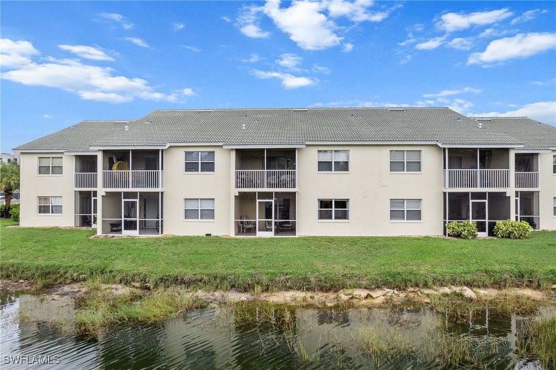 4965 Sandra Bay Drive, Unit 103 Naples, FL 34109 - Photo 24 of 30 a front view of a building with a garden