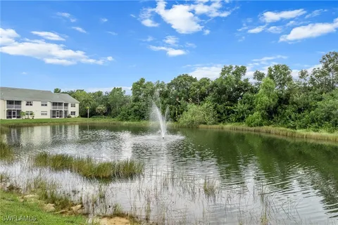 a view of a lake with houses in the background