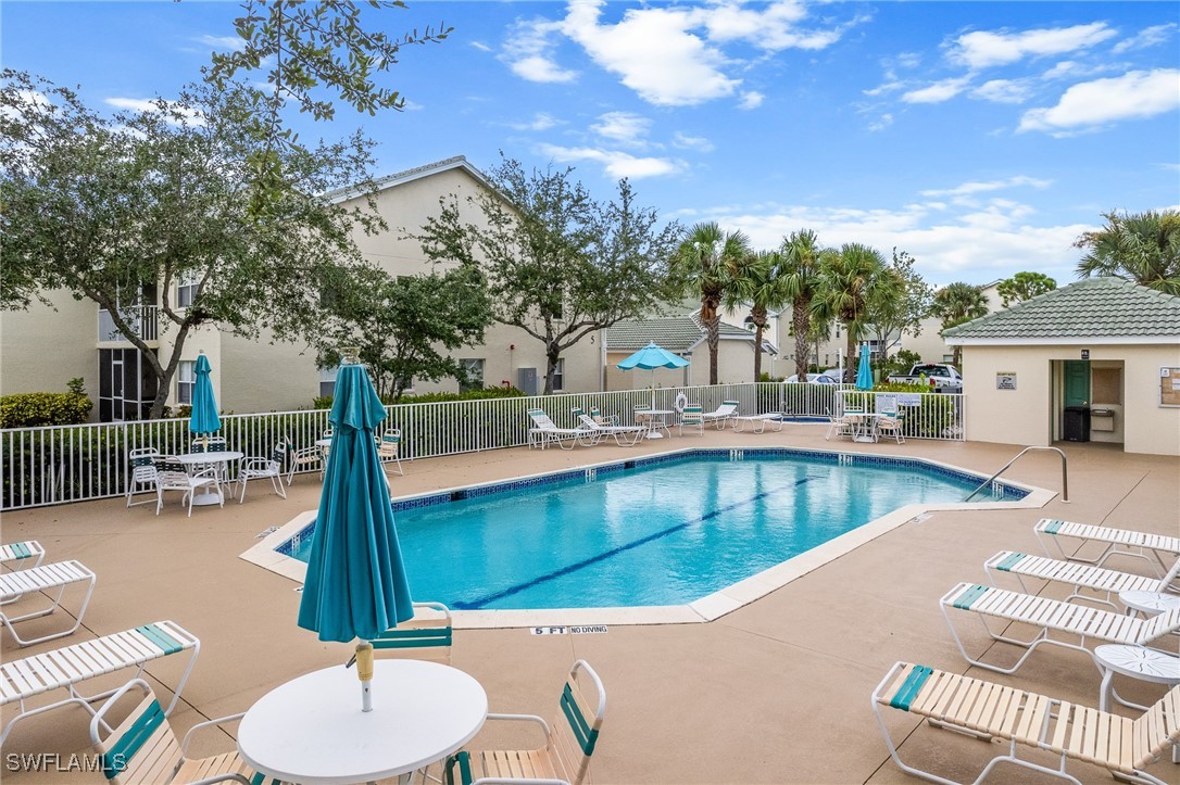 4965 Sandra Bay Drive, Unit 103 Naples, FL 34109 - Photo 30 of 30 a view of a patio with swimming pool
